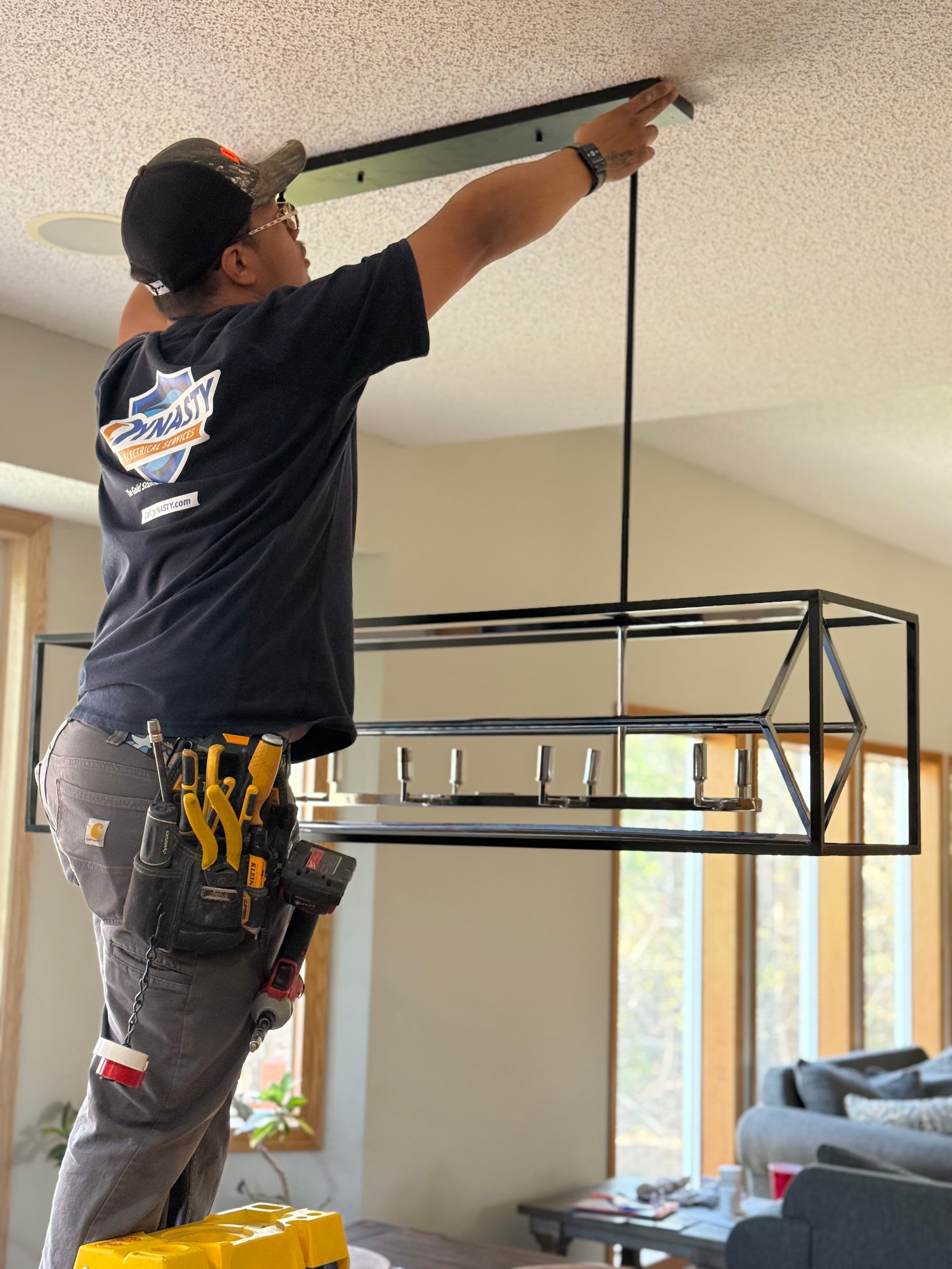 Project Drop chandelier installation in a dining room in inver grove heights image