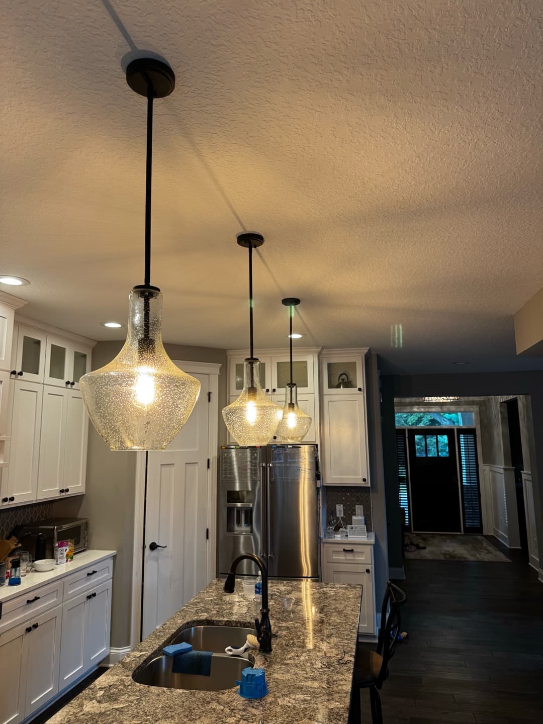 Seeded Glass Pendant Lights Installed Over a Minneapolis Kitchen Island image